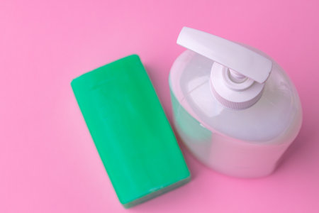 Hand antiseptic disinfection, soap bar on pink paper background.の写真素材