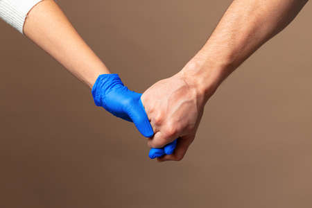 Handshake in a blue gloves, help concept. Personal hygiene during a pandemic