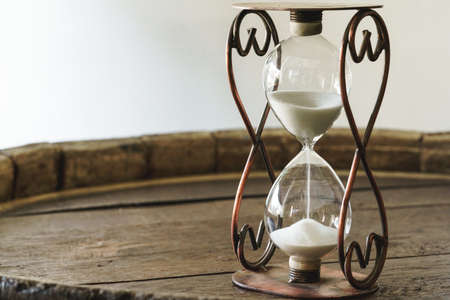 Sandglass on wooden bakground closeup. Time conceptの写真素材