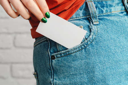 Girls hand holding blank white business cardの写真素材