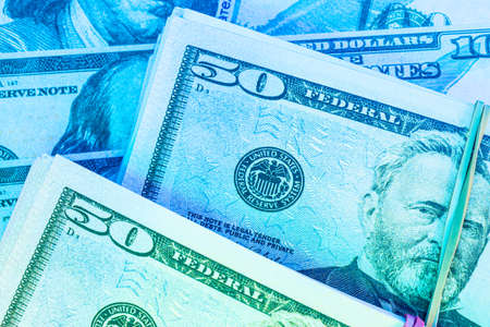 money background from dollars in neon light, close up