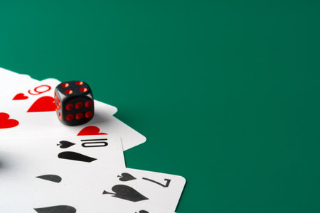 Dice and cards scattered on table close upの写真素材