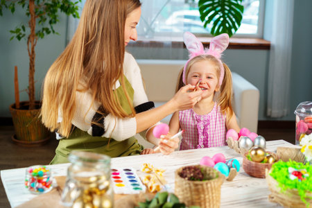 Cute family, mother and daughter preparing for Easter celebrationの写真素材