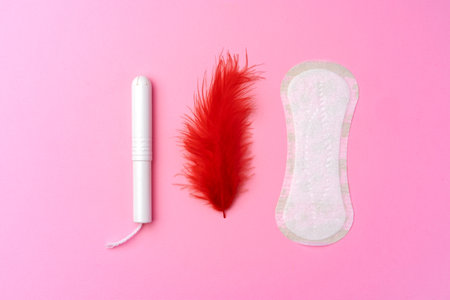 Female hygienic pad and tampons on pink backgroundの写真素材