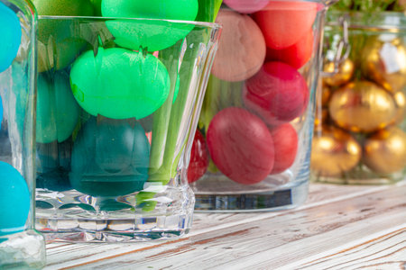 Glass jar with bright colored eggs for Easter celebration