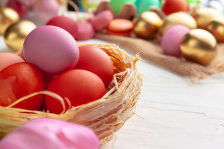 Easter composition with tulips and basket of painted eggs