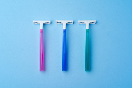 Set of disposable razors for women on blue backgroundの写真素材