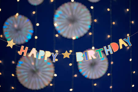 Happy birthday garland and decorations on blue background