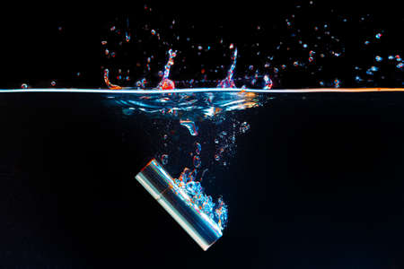 Lipstick case falling into the water with a splashの写真素材