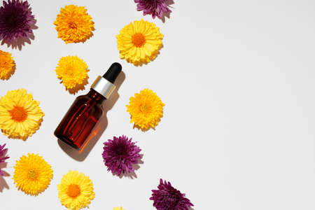 Cosmetic oil bottle on floral buds backgroundの写真素材