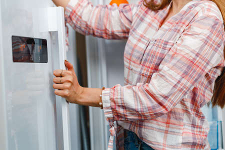 Close up of a woman opening fridge doorの写真素材