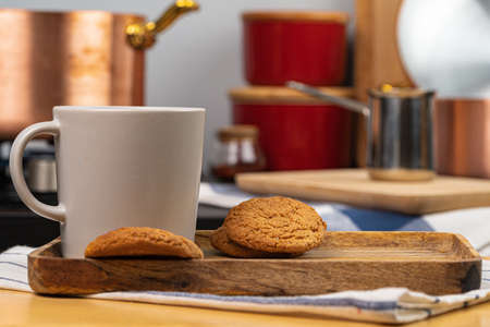 Cup of hot coffee on wooden board on kitchen tableの写真素材