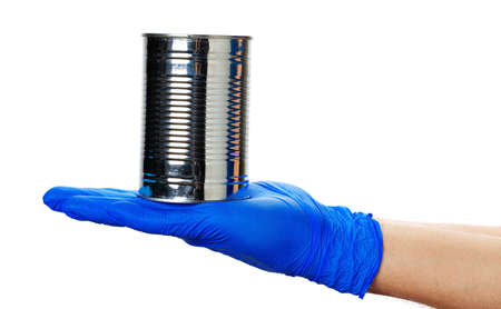Canned food in a hand in a glove on a white background.
