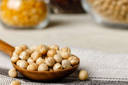 dried beans in wooden spoons on the tableの写真素材