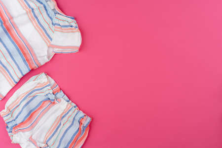 baby clothes on pink background top viewの写真素材