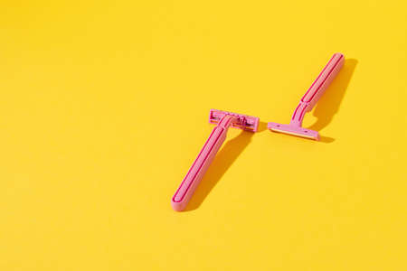 Studio shot of disposable razor tools on yellowの写真素材