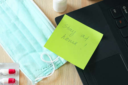 Medical protective mask on office table. Coronavirus spread prevention concept