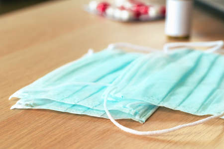 Medical protective mask on office table. Coronavirus spread prevention conceptの写真素材