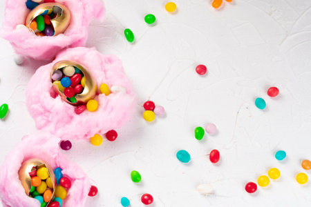 Egg shell with colorful candies inside in a decorative Easter nest