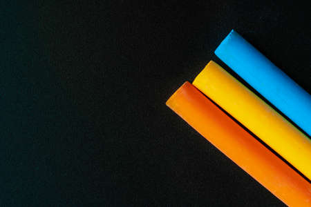 Colorful chalks close up on black background