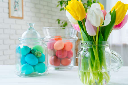 Fresh spring flowers with painted eggs for Easter celebration