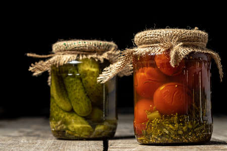 Jars with variety of pickled vegetables. Close up.