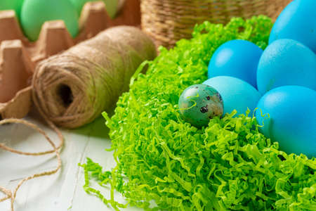 Blue painted eggs in a nest for Easter