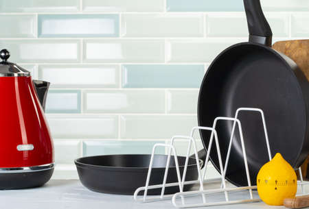 Clean and dry cooking pans on a kitchen counter