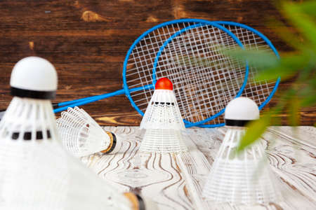Badminton equipment. Rackets and shuttlecock on wooden tableの写真素材