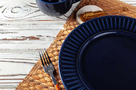 Wooden kitchen counter with new dishware on it
