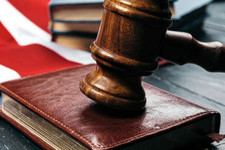 Image of wooden judge hammer on notepad
