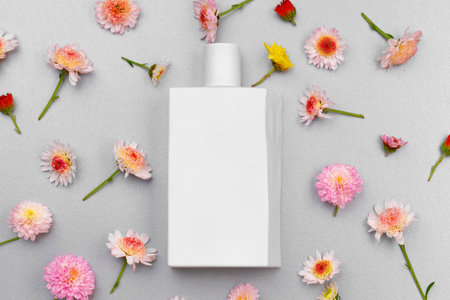 Bottle of fragrance surrounded by flower budsの写真素材