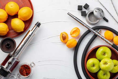 Shisha parts with apples and lemons on table
