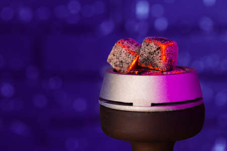 Burning hookah coals in hookah bowl close up