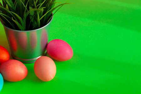 Pot with grass and colored Easter etggs