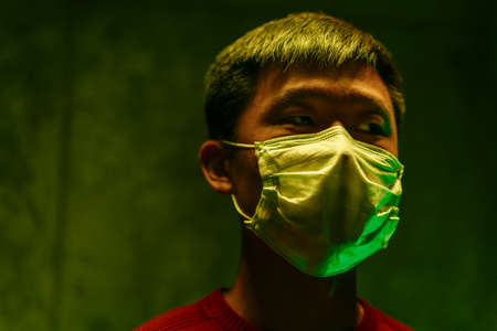 Portrait of a Chinese man wearing medical protective mask. Coronavirus protection conceptの写真素材