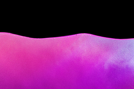 Pink bubbly boiling water against black background