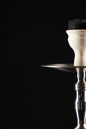 Ceramic tobacco bowl of hookah on black backgroundの写真素材