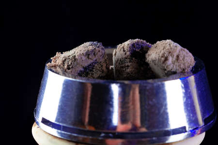 Shisha hookah with hot coals on black background