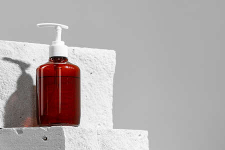 Skincare cosmetic jar on gray concrete blockの写真素材