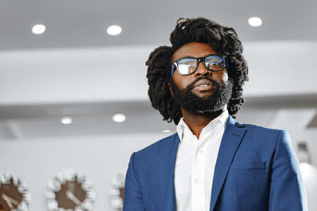 Portrait of african american businessman standing in lobby