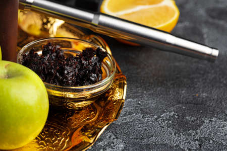 Shisha parts with apples and lemons on tableの写真素材