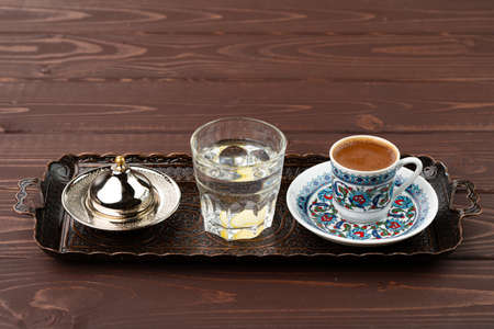Cup of coffee in oriental style on metal trayの写真素材