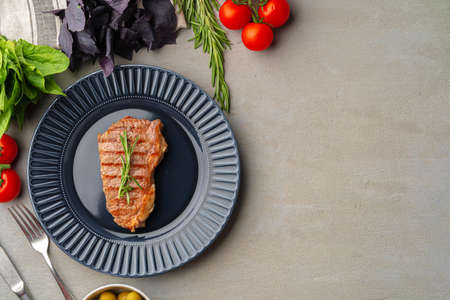 Grilled beef steak served on blue plateの写真素材