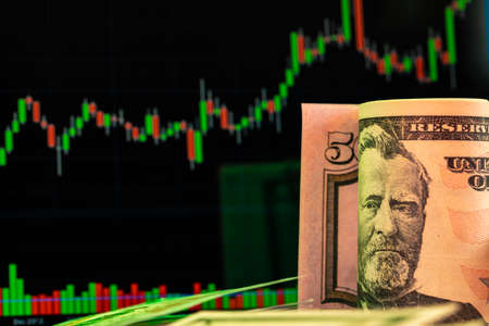 American dollar banknotes and graph on black backgroundの写真素材