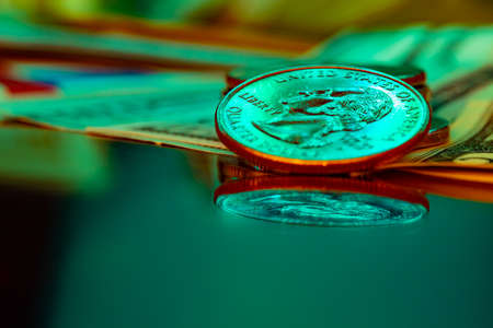 American dollar banknotes and coins on black background