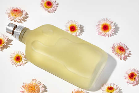 Bottle of fragrance surrounded by flower buds