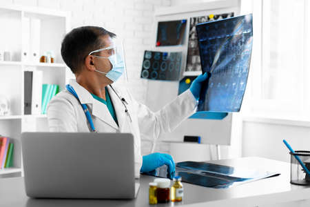 Doctor examining lungs x-ray scan in his office in hospitalの写真素材