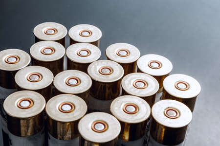 Rifle bullets or cartridges on black shiny background