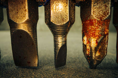 Metal screwdriver bits on concrete background macroの写真素材